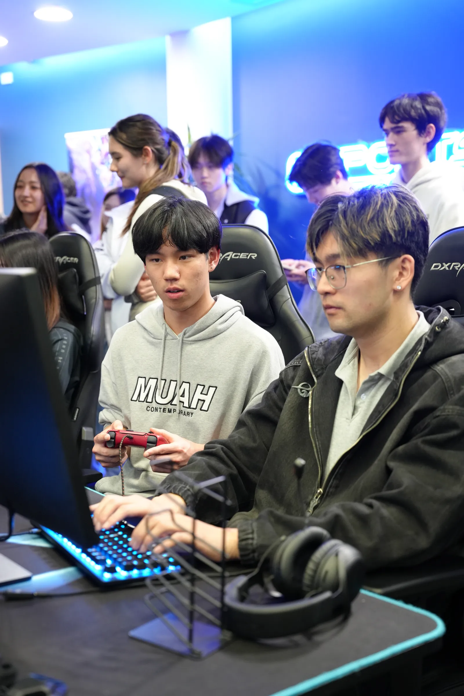 Two members playing with controllers at the welcome party