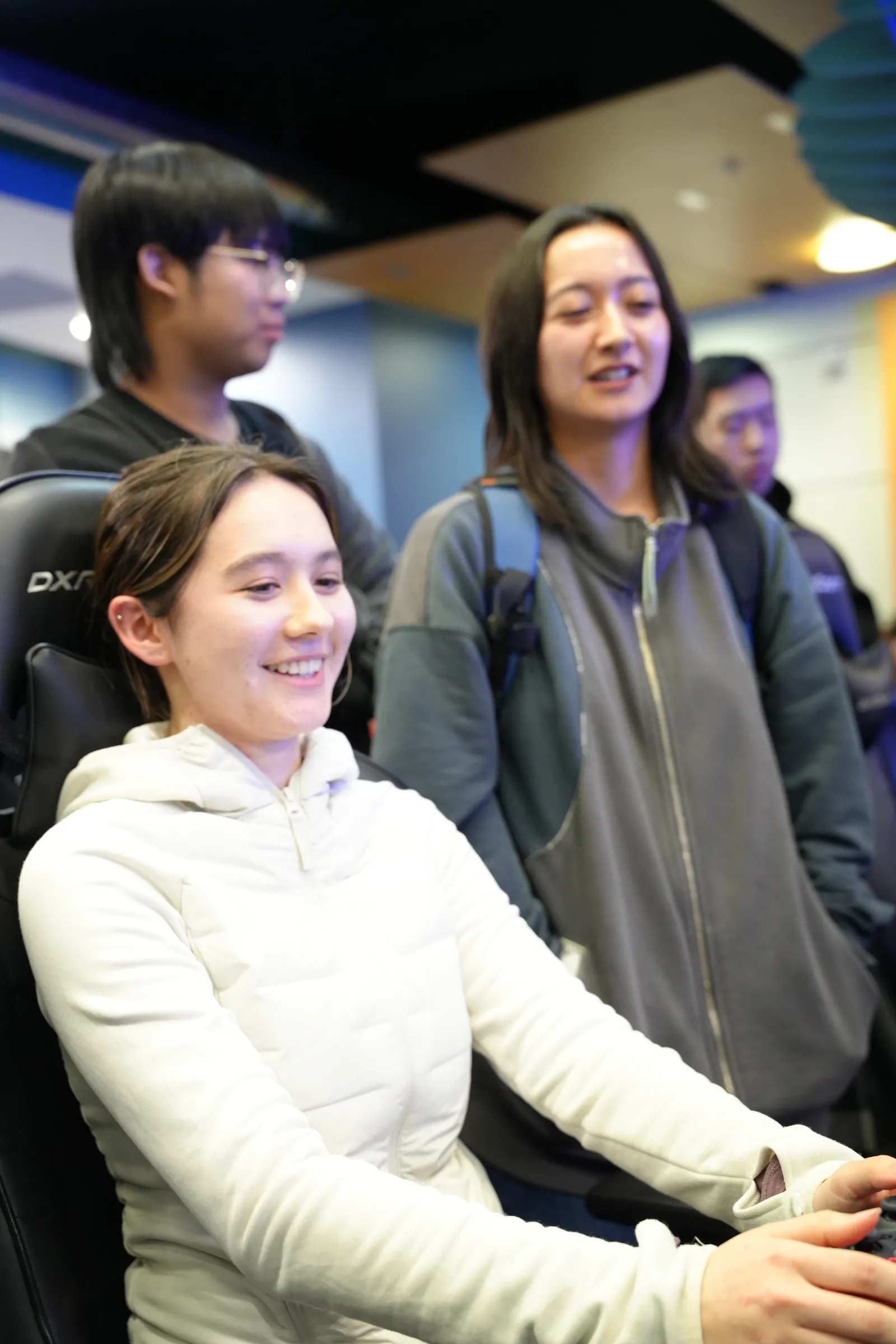 A member smiling while playing at the welcome party