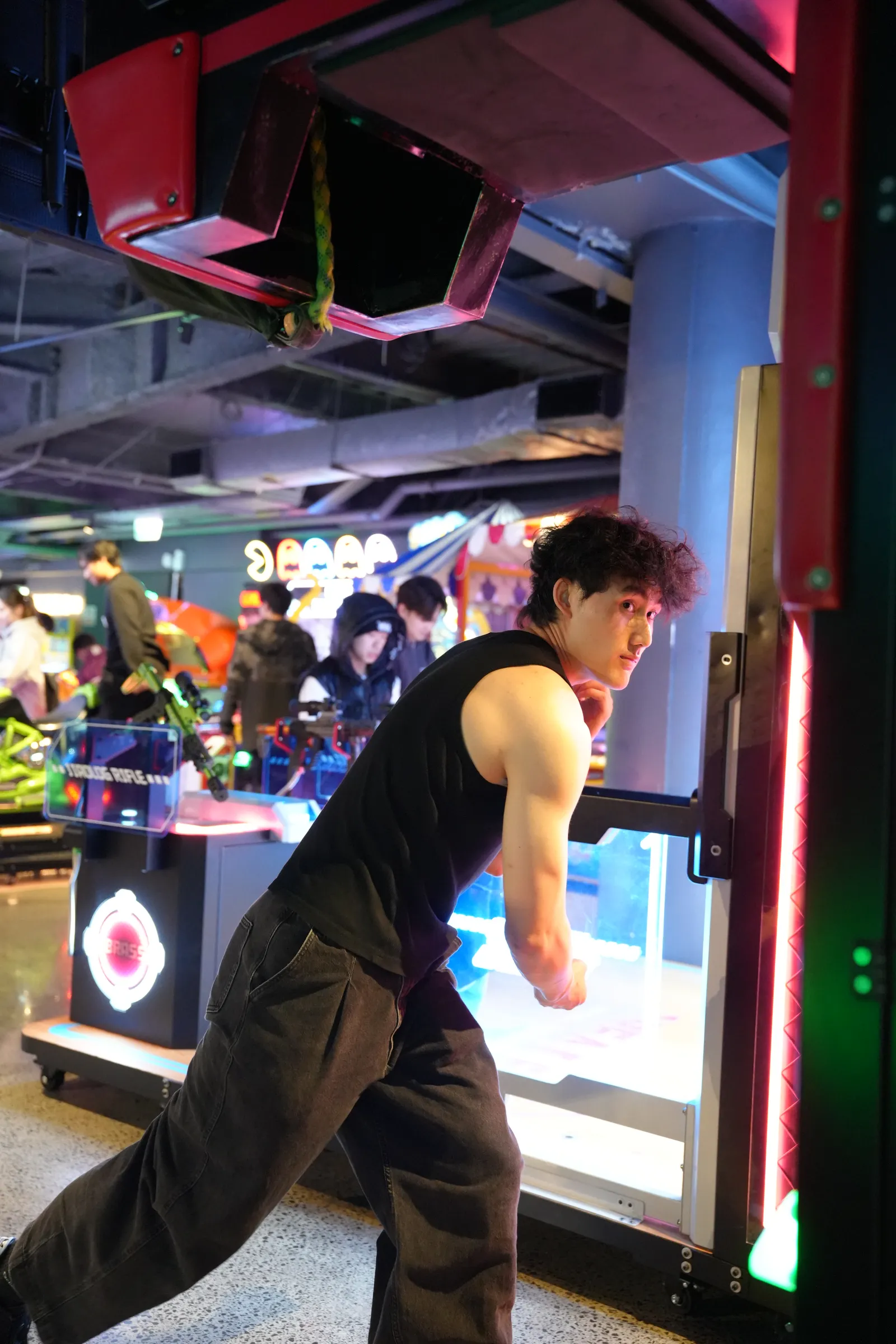 A member playing a punching machine at arcade night
